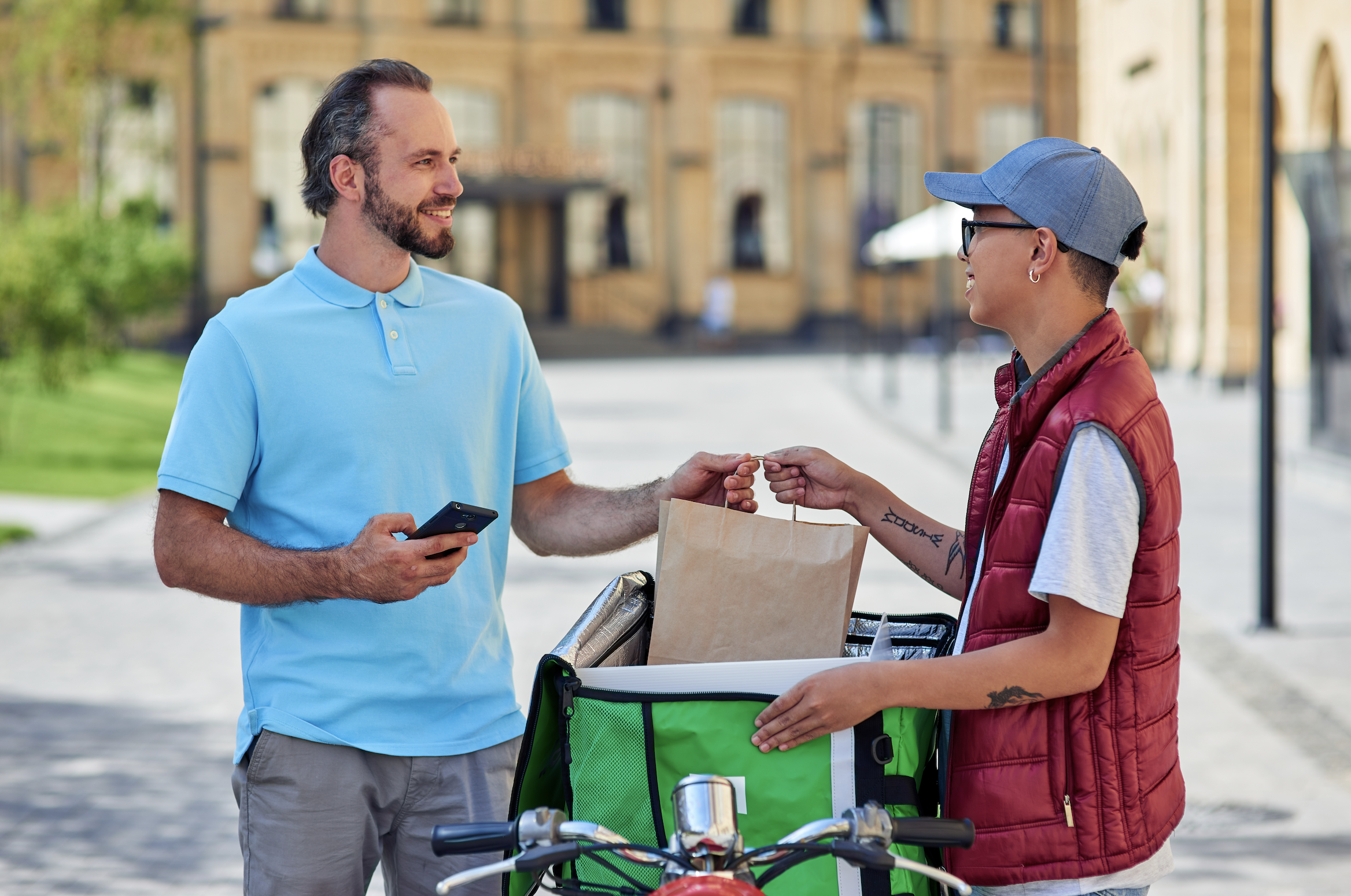 delivery driver handing over order to the customer